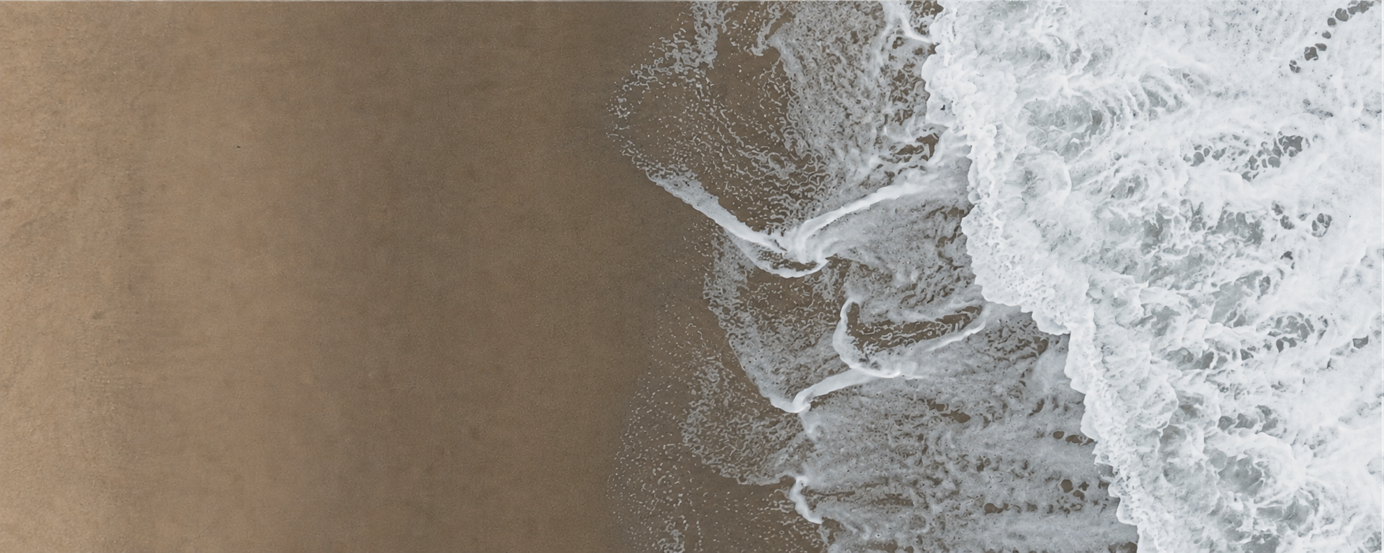 Aerial view of waves washing over the beach
